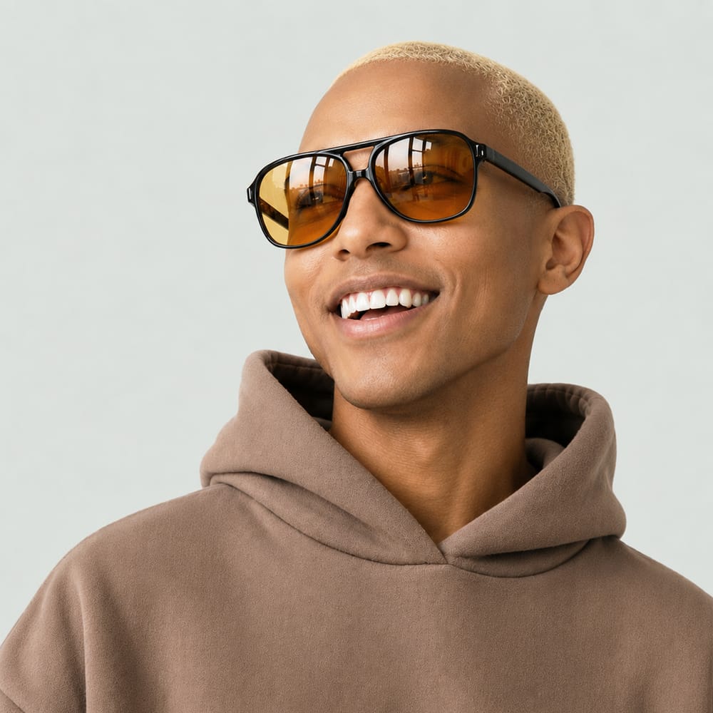 Confident young man wearing sunglasses in neutral streetwear