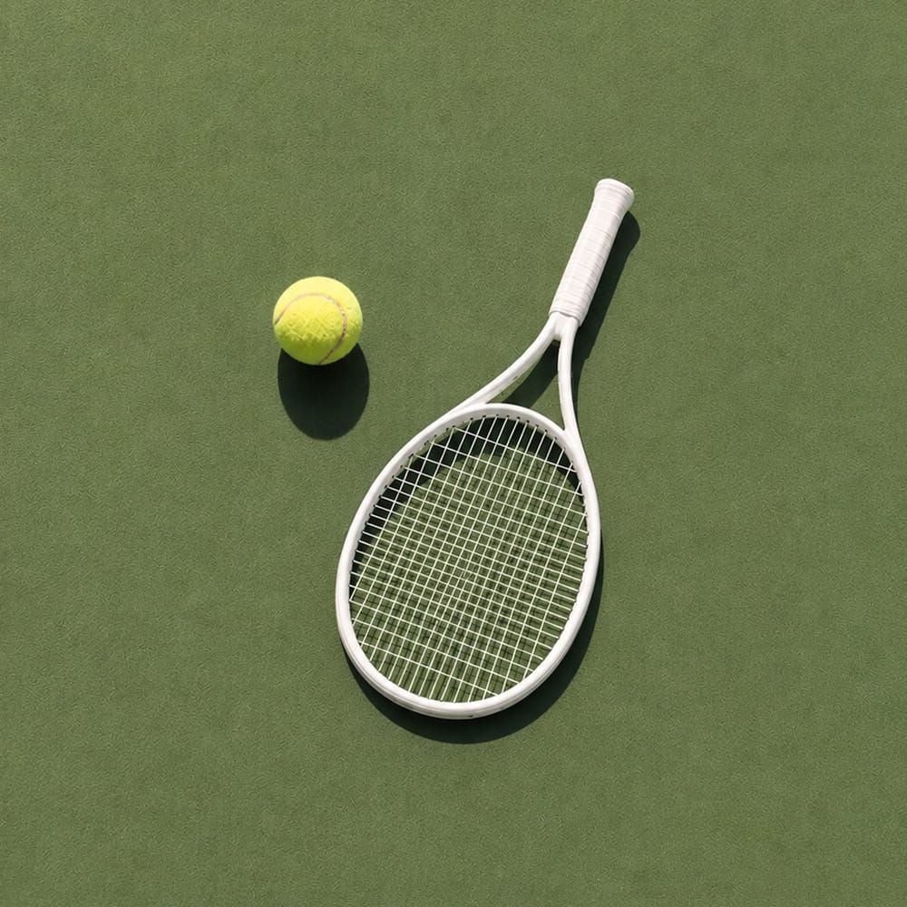 Tennis racket and ball flat lay on olive green background minimal sports photography