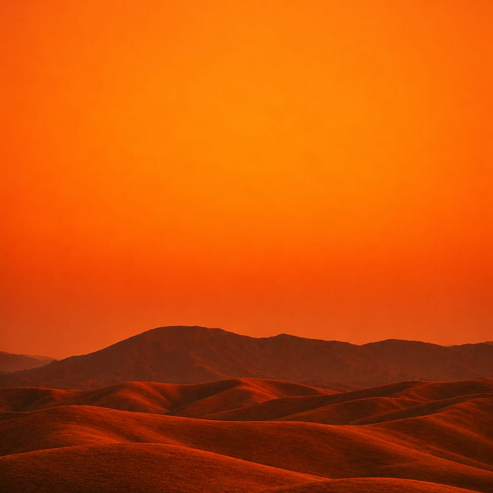 Desert sand dunes at golden hour with deep orange gradient sky