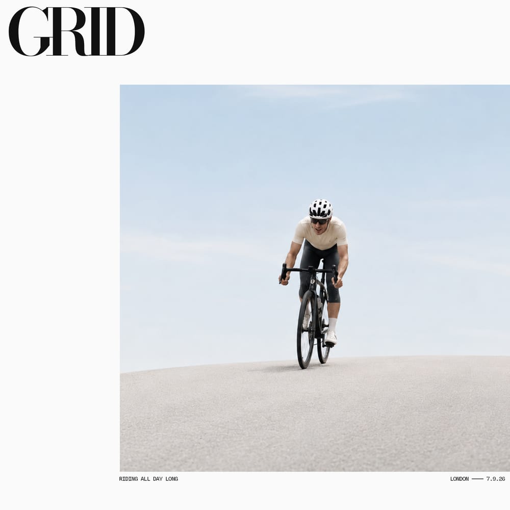 Lone cyclist riding through vast empty desert landscape minimal photography