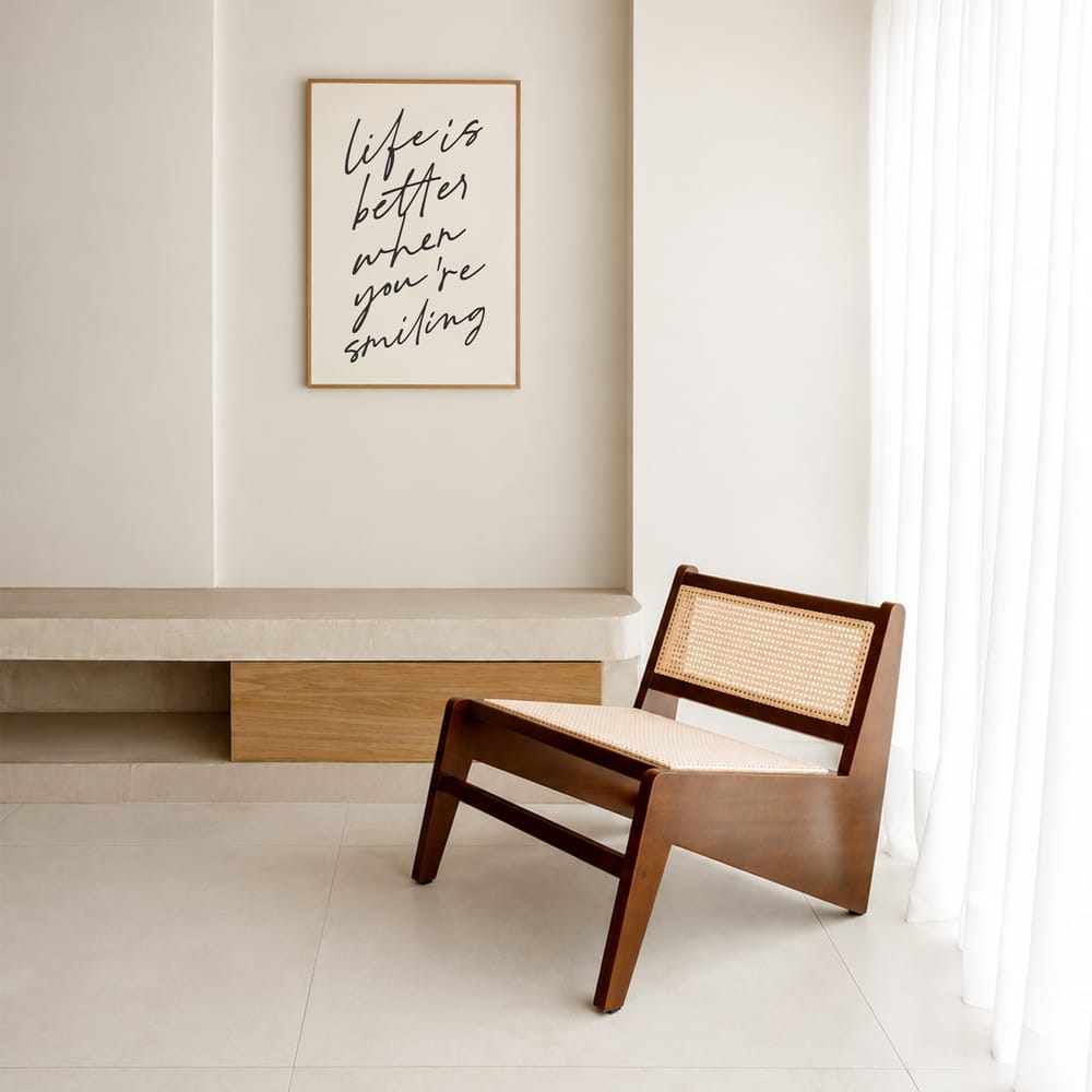 Minimal interior with wooden chair and framed quote on white wall warm natural light
