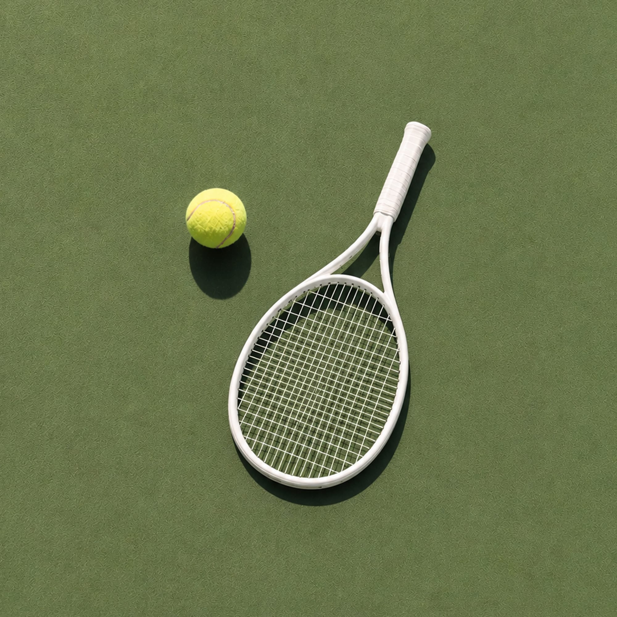 Tennis racket and ball flat lay on olive green background minimal sports photography