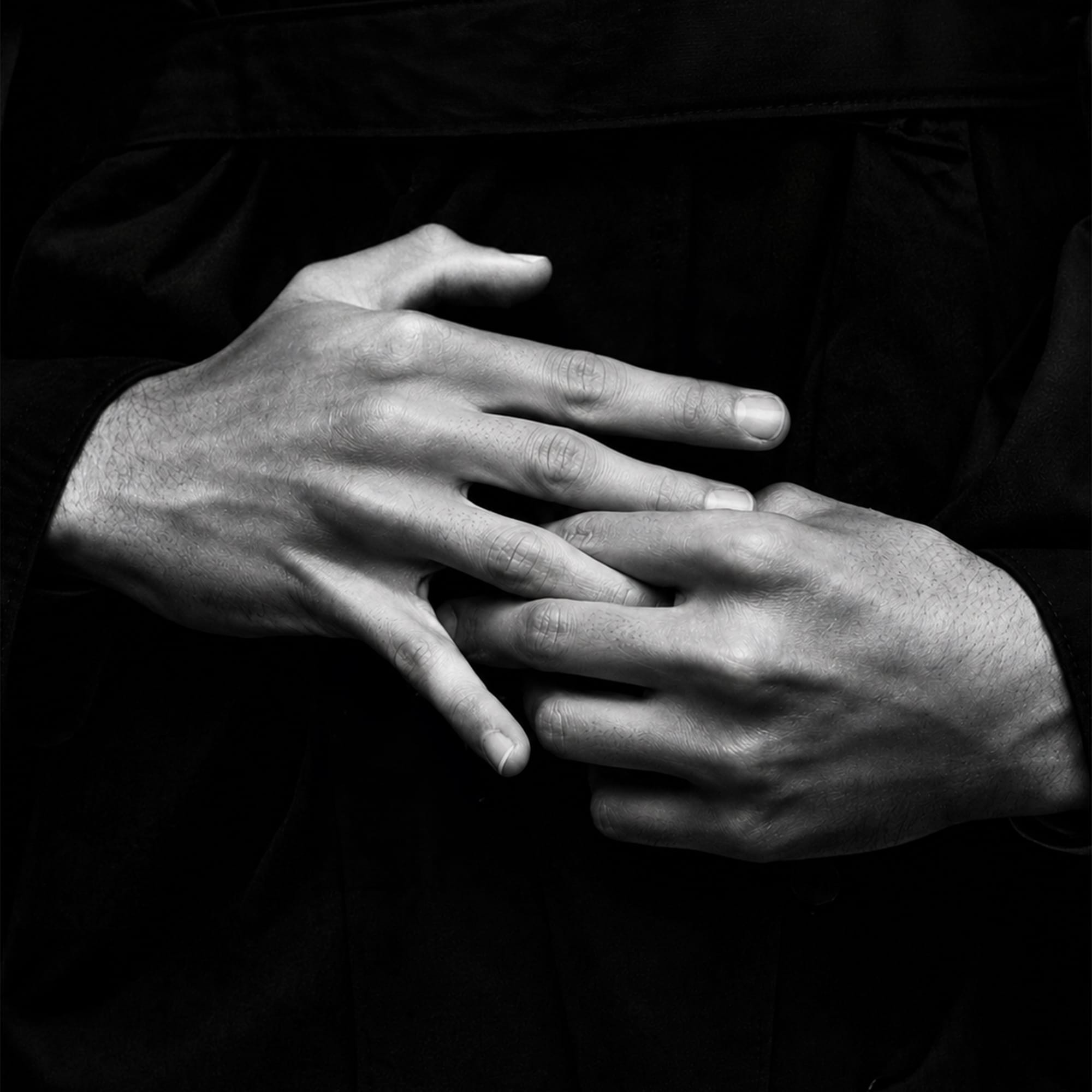 Close-up of hands in dark moody black and white detail photography